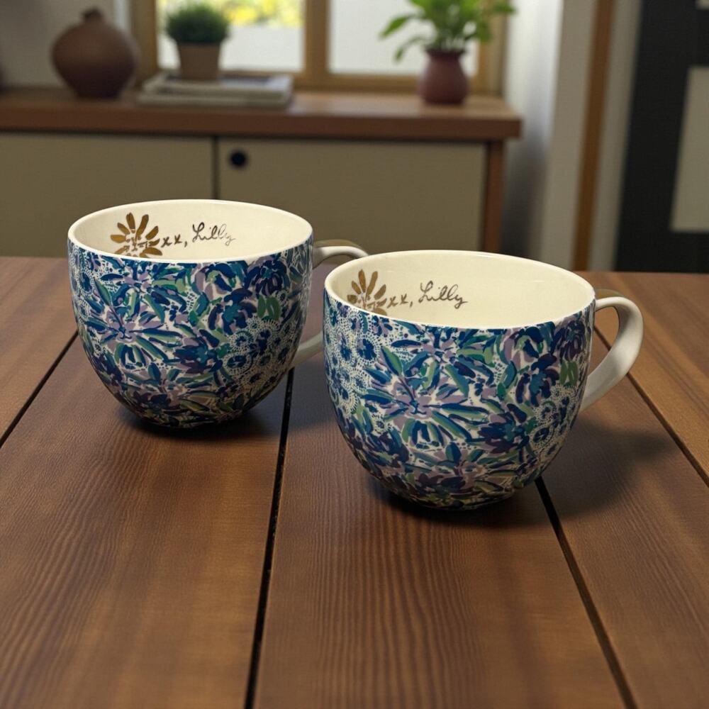 A pair of Lilly Pulitzer ceramic mugs with floral print and gold accents.